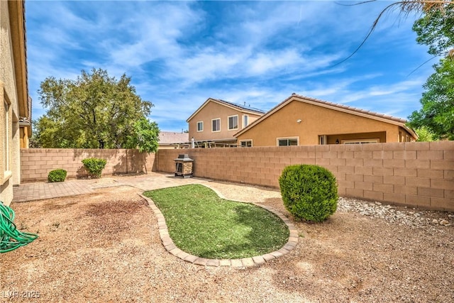 view of yard with a fenced backyard and a patio area