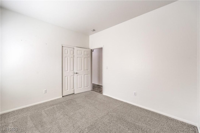 unfurnished room featuring baseboards and carpet flooring