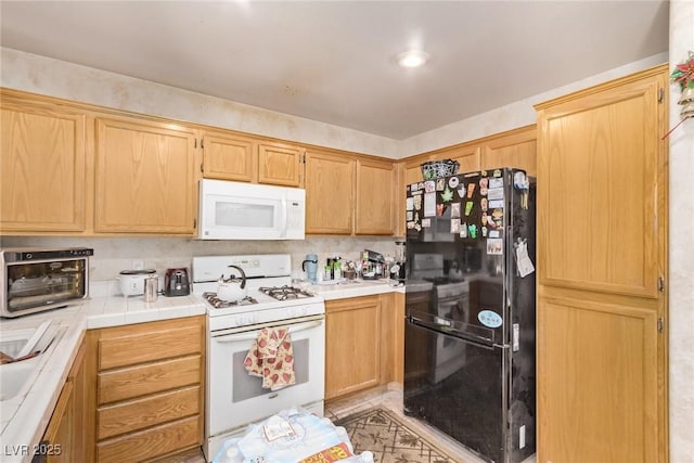 kitchen with a toaster, tile countertops, and white appliances