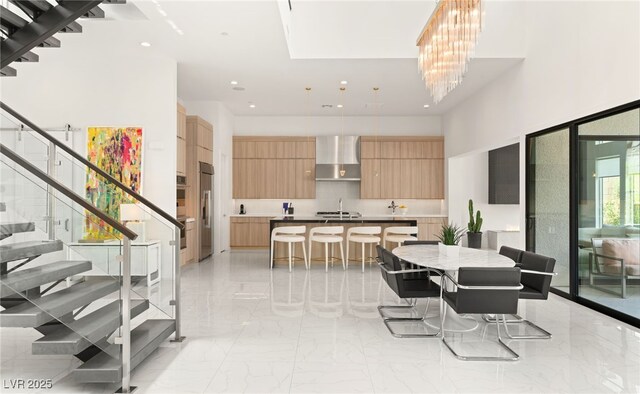 dining space with marble finish floor, a high ceiling, stairs, and recessed lighting