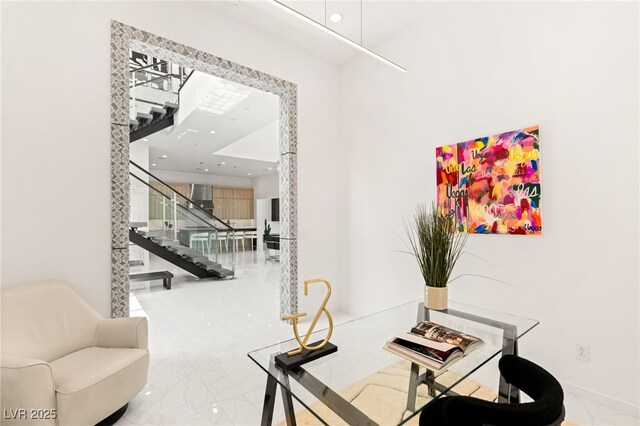 interior space featuring recessed lighting, baseboards, marble finish floor, and stairs