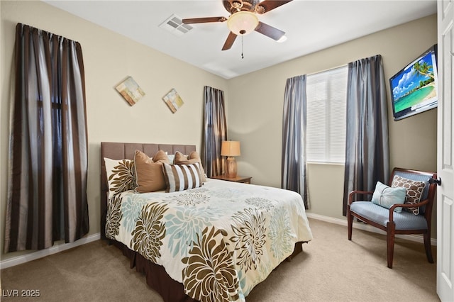 carpeted bedroom with baseboards, a ceiling fan, and visible vents