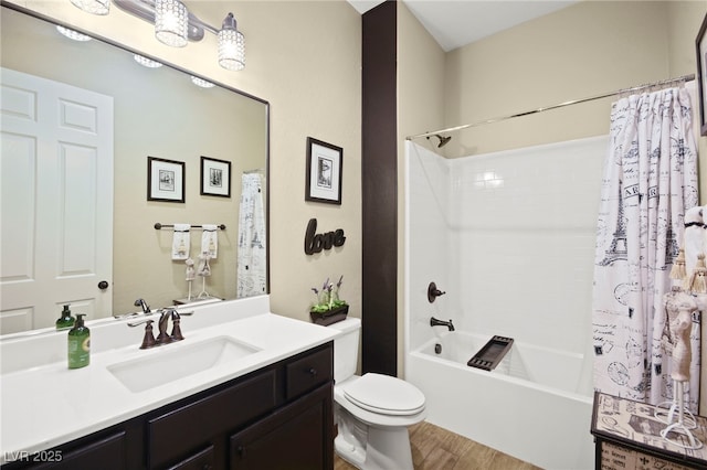 bathroom featuring toilet, vanity, wood finished floors, and shower / bath combo with shower curtain