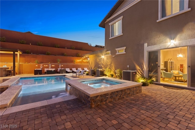 view of pool with a fenced in pool, outdoor lounge area, central AC unit, a patio area, and an in ground hot tub