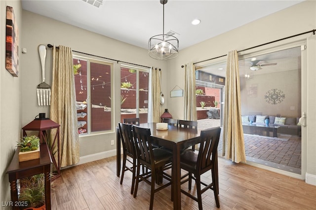 dining space featuring recessed lighting, wood finished floors, baseboards, and ceiling fan with notable chandelier