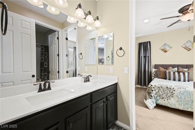 bathroom with double vanity, baseboards, ceiling fan, and a sink
