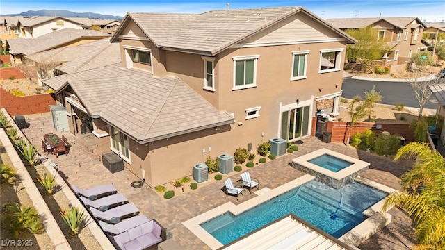 rear view of house with a residential view, central AC, a fenced backyard, and stucco siding