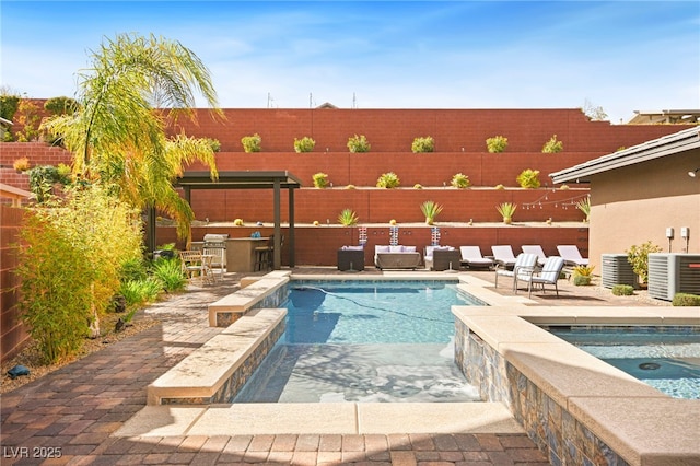 view of swimming pool featuring central air condition unit, a patio, a fenced backyard, and an in ground hot tub