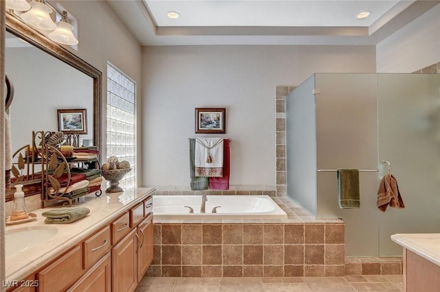 bathroom with a bath, vanity, and a walk in shower