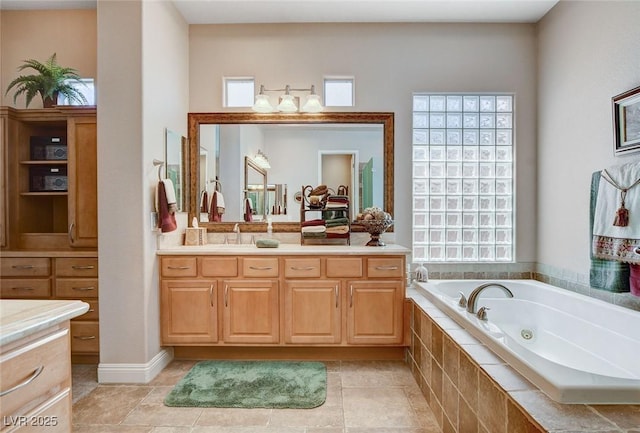 full bathroom featuring tile patterned floors, vanity, and a whirlpool tub