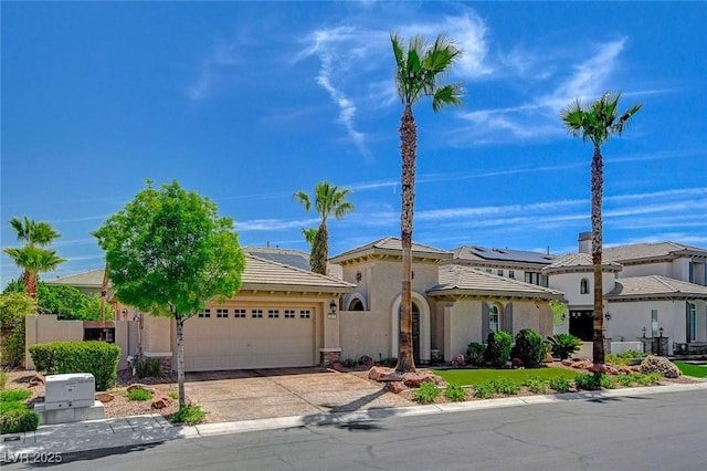mediterranean / spanish house with stucco siding, concrete driveway, and a garage