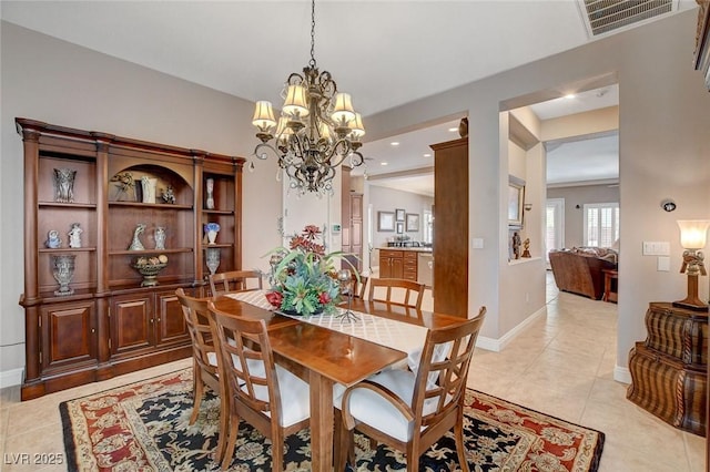 dining area with baseboards, an inviting chandelier, visible vents, and light tile patterned floors