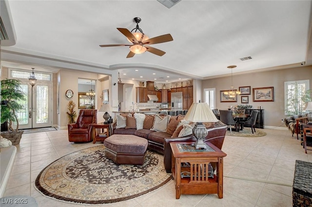 living room featuring plenty of natural light, baseboards, a wall mounted AC, and light tile patterned floors