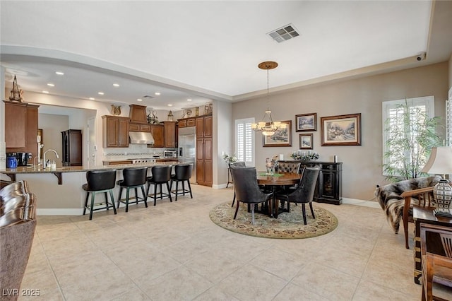 dining room with light tile patterned flooring, a chandelier, baseboards, visible vents, and recessed lighting