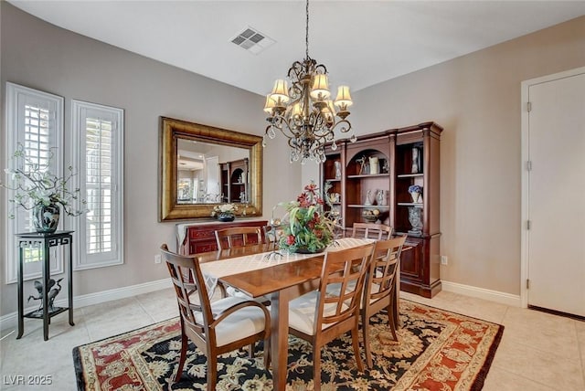 dining room with baseboards, visible vents, a chandelier, and light tile patterned floors