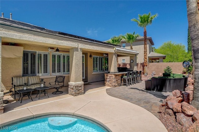 back of house featuring a ceiling fan, outdoor dry bar, outdoor lounge area, fence, and a patio area
