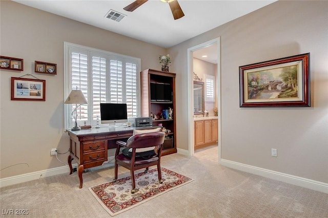 home office featuring light carpet, visible vents, a wealth of natural light, and ceiling fan