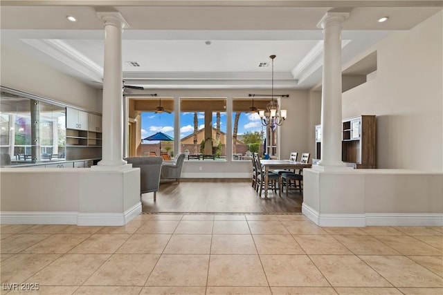 4624 Leon De Oro Dr, Las Vegas, NV 89129 - living area with decorative columns, a tray ceiling, light tile patterned flooring, ornamental molding, and a chandelier