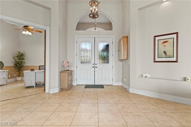 4624 Leon De Oro Dr, Las Vegas, NV 89129 - foyer with a ceiling fan, baseboards, light tile patterned flooring, french doors, and a towering ceiling