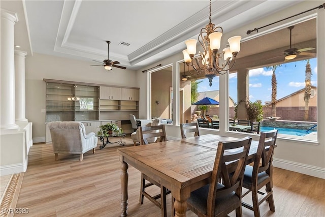 4624 Leon De Oro Dr, Las Vegas, NV 89129 - dining area with ceiling fan, ornate columns, a tray ceiling, light wood-style flooring, and baseboards