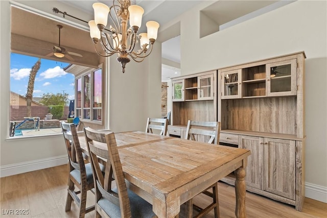 4624 Leon De Oro Dr, Las Vegas, NV 89129 - dining area featuring a ceiling fan, baseboards, a chandelier, and light wood-type flooring
