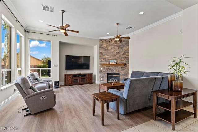 4624 Leon De Oro Dr, Las Vegas, NV 89129 - living area featuring ceiling fan, crown molding, light wood finished floors, a stone fireplace, and recessed lighting