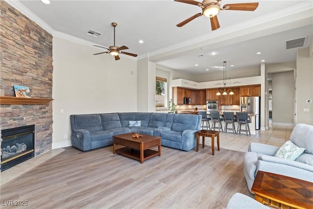 4624 Leon De Oro Dr, Las Vegas, NV 89129 - living area with ceiling fan, ornamental molding, recessed lighting, light wood-style floors, and a fireplace