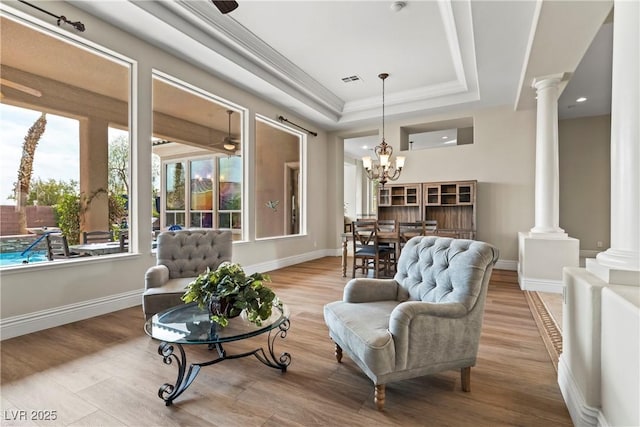 4624 Leon De Oro Dr, Las Vegas, NV 89129 - sitting room with ornate columns, wood finished floors, a tray ceiling, ornamental molding, and recessed lighting