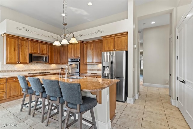 4624 Leon De Oro Dr, Las Vegas, NV 89129 - kitchen with stainless steel appliances, light tile patterned floors, brown cabinets, tasteful backsplash, and recessed lighting