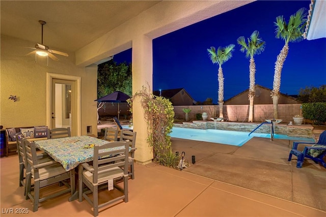 4624 Leon De Oro Dr, Las Vegas, NV 89129 - patio at night with a fenced backyard, a ceiling fan, a patio area, and outdoor dining space