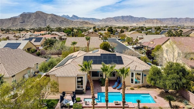 4624 Leon De Oro Dr, Las Vegas, NV 89129 - aerial perspective of suburban area featuring a pool area and a mountainous background