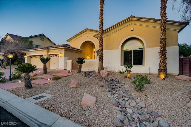4624 Leon De Oro Dr, Las Vegas, NV 89129 - mediterranean / spanish-style home featuring stucco siding, a garage, and a tiled roof