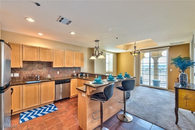 2405 W Serene Ave Unit 703, Las Vegas, NV 89123 - kitchen with stainless steel appliances, a peninsula, visible vents, and a sink
