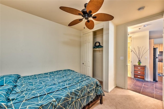 2405 W Serene Ave Unit 703, Las Vegas, NV 89123 - carpeted bedroom featuring freestanding refrigerator, a closet, baseboards, and ceiling fan