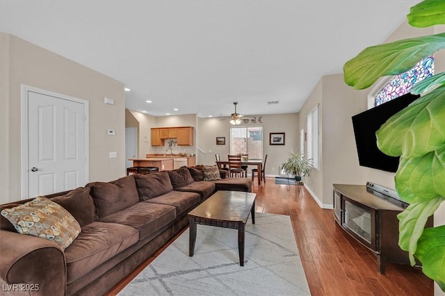 living area with recessed lighting, hardwood / wood-style floors, visible vents, baseboards, and ceiling fan
