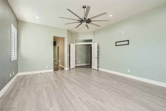 spare room featuring light wood finished floors, a ceiling fan, baseboards, and recessed lighting