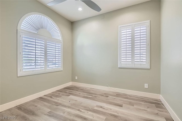 empty room featuring baseboards, a ceiling fan, and wood finished floors