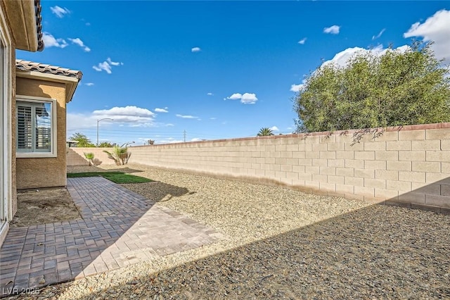 view of yard featuring a fenced backyard and a patio