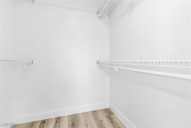 spacious closet with light wood-style floors