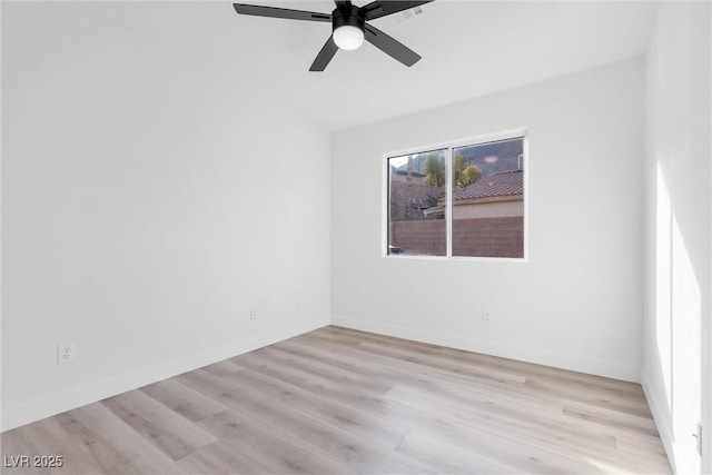 empty room featuring light wood-style flooring, baseboards, and ceiling fan
