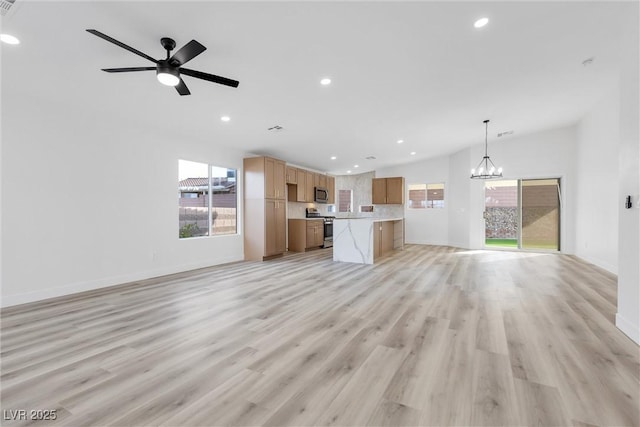 unfurnished living room with baseboards, recessed lighting, and light wood-style floors
