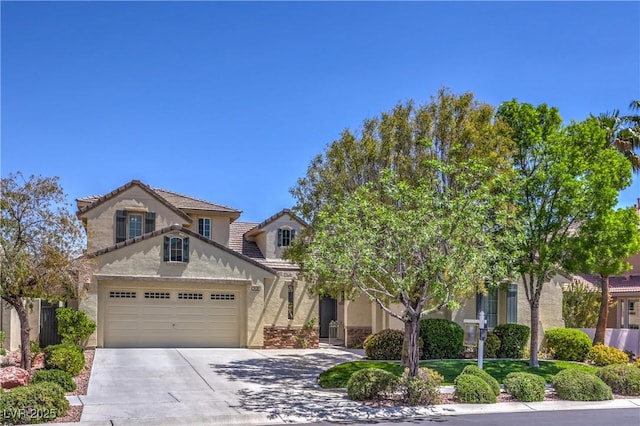 view of front of house with stucco siding, concrete driveway, a tiled roof, and a garage