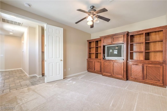 unfurnished living room featuring a ceiling fan, light carpet, baseboards, stone finish floor, and visible vents