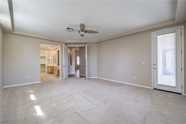unfurnished room with visible vents, a ceiling fan, and baseboards