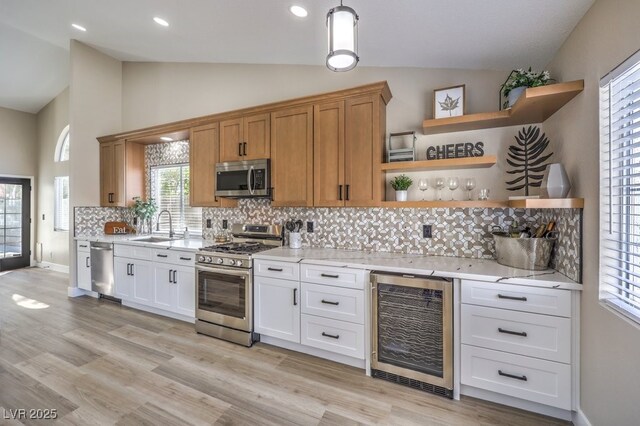 kitchen with open shelves, a sink, stainless steel appliances, and wine cooler