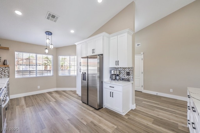 kitchen with backsplash, light wood finished floors, white cabinetry, and stainless steel fridge with ice dispenser