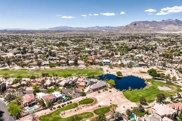 drone / aerial view featuring view of golf course, a residential view, and a water and mountain view