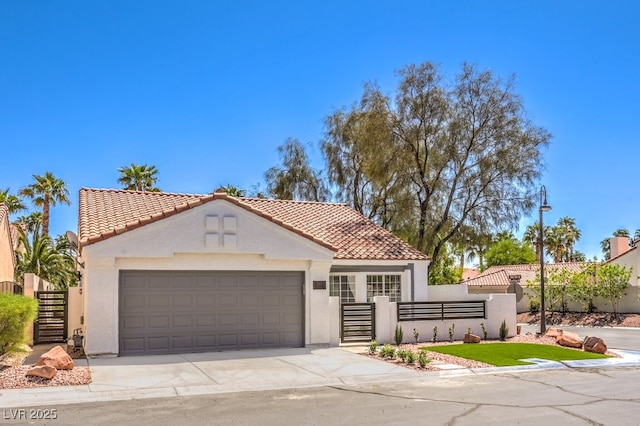 mediterranean / spanish house featuring a fenced front yard, stucco siding, concrete driveway, a tile roof, and a garage