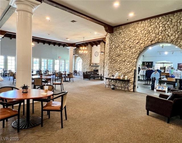 interior space featuring recessed lighting, a healthy amount of sunlight, beam ceiling, and ornate columns