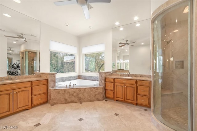 bathroom with ceiling fan, a stall shower, and a sink